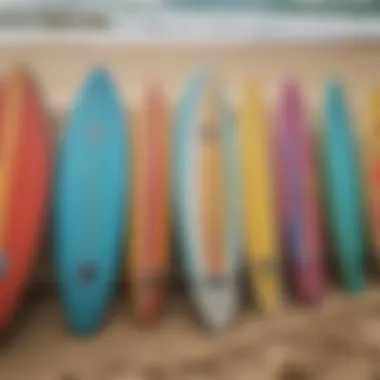 A close-up of surfboards lined up on the sandy shore showcasing vibrant designs.