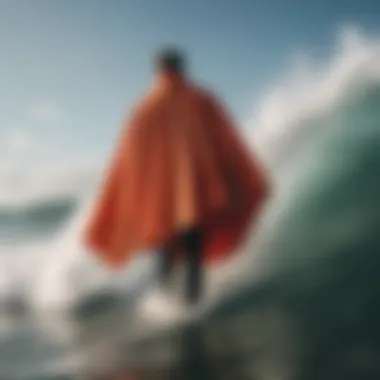 Surfer wearing a poncho after catching a wave