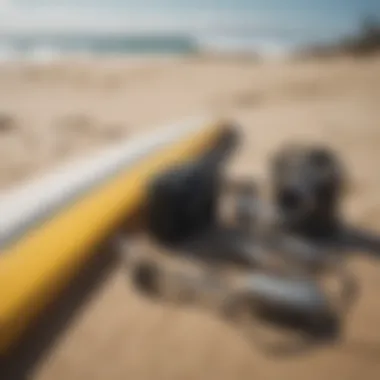 Close-up of surf gear and accessories on the sand