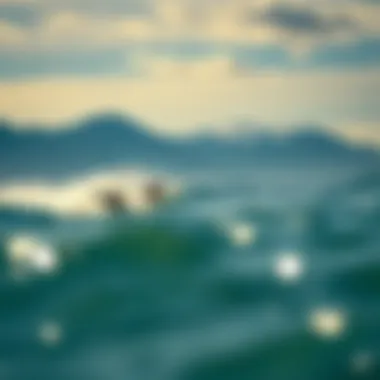 Surfers catching waves at Alaïa Bay with dramatic mountain backdrop