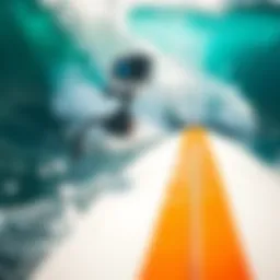 GoPro backpack mount attached to a surfboard during a wave ride