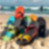 A vibrant collection of surf style sandals displayed on a sandy beach.