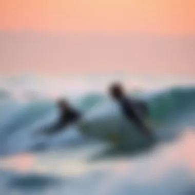 Surfers Riding the Waves at Dusk Surfers enjoying the waves at sunset