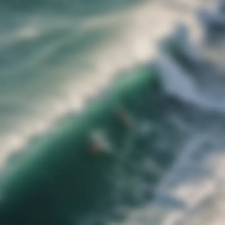 Aerial view of surfers riding waves at a famous California beach