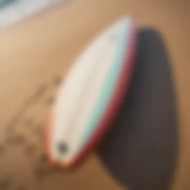 Surfboard Emblematic of Coastal Culture Surfboard resting on the sandy beach