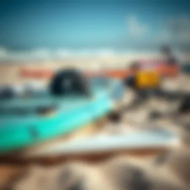 Close-up of windsurfing equipment laid out on a sandy beach