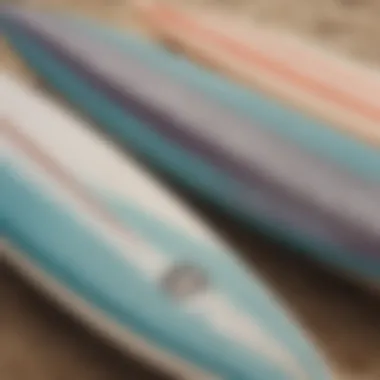 Close-up of surfboards lined up on the beach