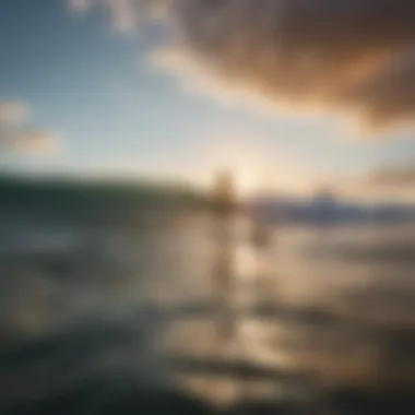 A paddleboarder gliding over calm waters at sunrise