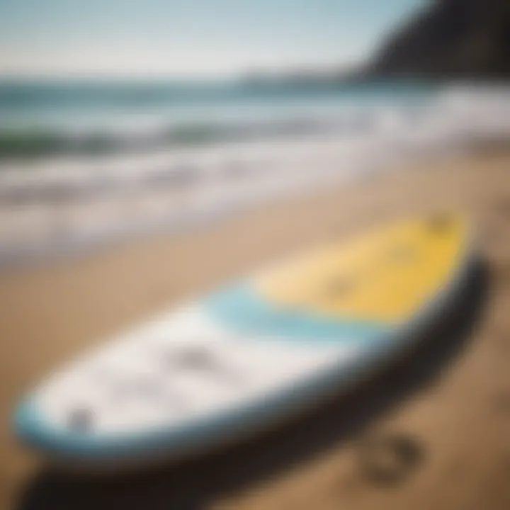 Essential paddle board equipment laid out on a sandy beach