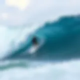 A surfer catching a wave at Kaimu Beach