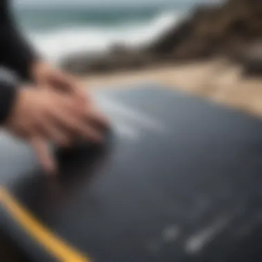 Surfboard being treated with Black Edge Detailer