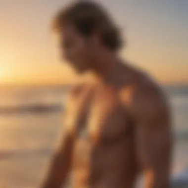 Surfer wearing a Saint Christopher necklace on a beach during sunset