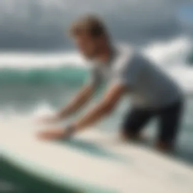 Person demonstrating a technique for wax removal on a surfboard