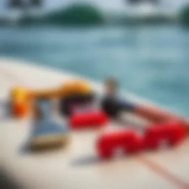 Essential Tools for Wax Removal A variety of surf wax removal tools laid out on a surfboard